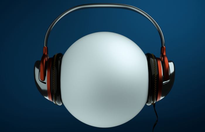A white sphere wears over-the-ear headphones